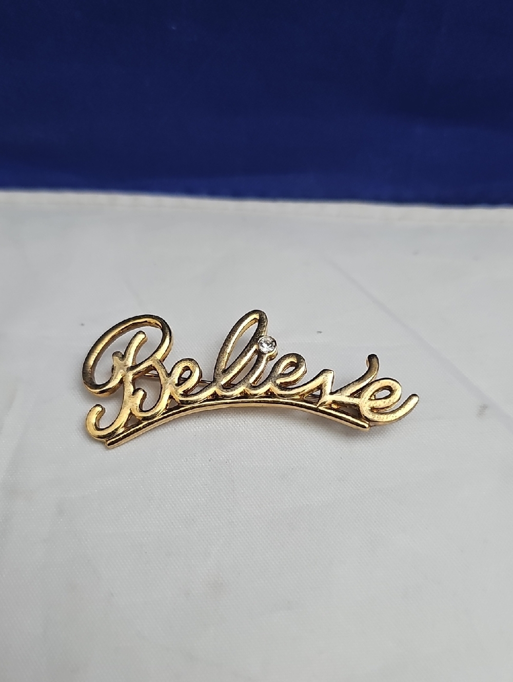 "Believe" Gold Script Brooch with Clear Stone